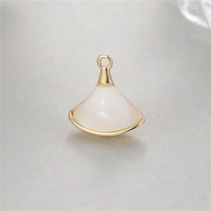 Detail shot of fan-shaped pendant with white mother-of-pearl and gold metal plating