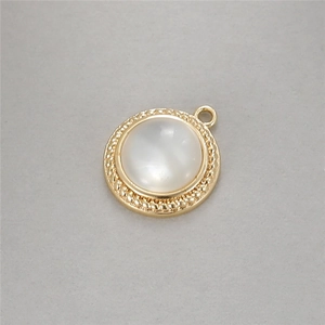 Detailed macro of gold rope-textured pendant with a white pearlescent shell inlay