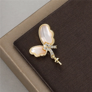 Exquisite gold butterfly pendant with white shell wings and shimmering zircon accents