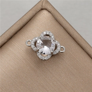 Macro view of clover jewelry connector with clear zircon and silver finish for DIY bracelets