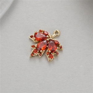 Detail of maple leaf pendant with red zircons and gold setting for DIY jewelry