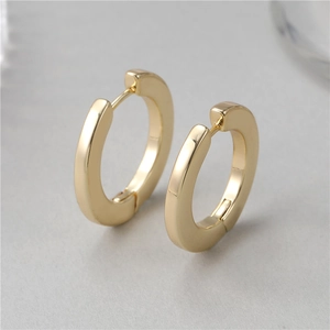 Polished thick gold hoop earrings for women and men featuring a sleek minimalist design