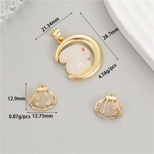 Macro detail of 14K gold plated rabbit and starfish pendants with size measurements