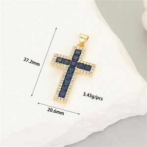 Detail of 14K gold cross pendant with blue center stone and white zircon accents