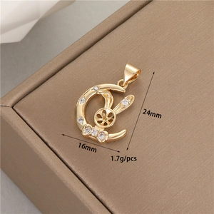 Detailed view of 14K gold plated rabbit pendant with zircon settings and pearl mount base
