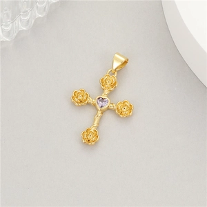 Detail of 14K gold cross pendant with rose-shaped ends and a heart-shaped purple zircon