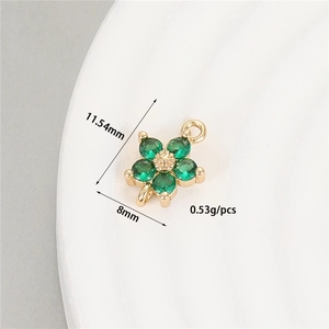 Macro view of gold flower pendant with green stones and 11.54mm dimension details