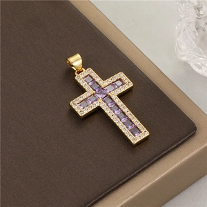 Detail of 14K gold cross pendant with purple zircon stones and white diamond accents