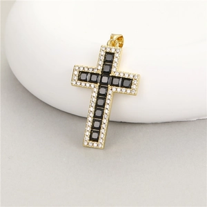 Macro detail of 14K gold cross pendant with black zircon and white pavé setting