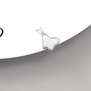 Detailed close-up of a 14K gold butterfly shell pendant for jewelry making