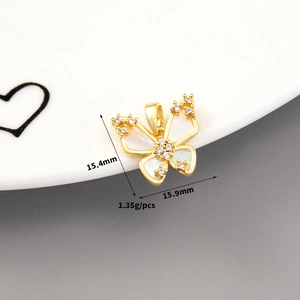 Macro view of 14K gold butterfly pendant with shell inlay and zircon accents