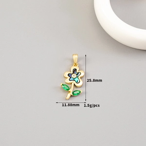 Detail of 14K gold floral pendant with shell petals, green gems, and size measurements