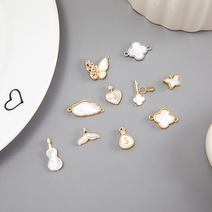 Elegant gold and silver mop charms in butterfly, clover, and gourd shapes for DIY jewelry