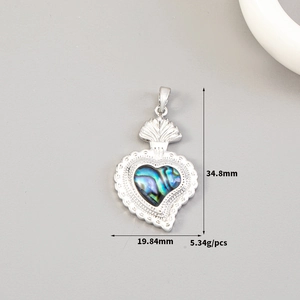 Detailed size view of silver heart pendant with colorful shell inlay and ornate engraving