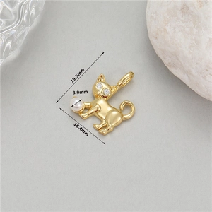 Macro view of 14K gold plated cat pendant with zircon eyes and 3.9mm pearl accent