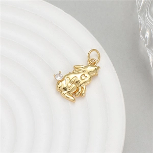 Golden bunny pendant with heart pattern and zircon accent on white ceramic tray