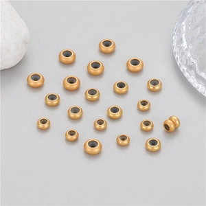 Macro shot of gold-plated spacer beads with matte finish for DIY jewelry making supplies