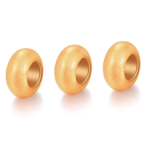 Macro detail of gold frosted finish spacer beads with polished inner holes for DIY jewelry
