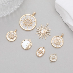 Assorted 14K gold solar and celestial pendants with zircon and white shell inlays