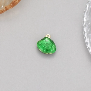 Macro shot of green shell pendant with golden loop and textured stripes for jewelry making