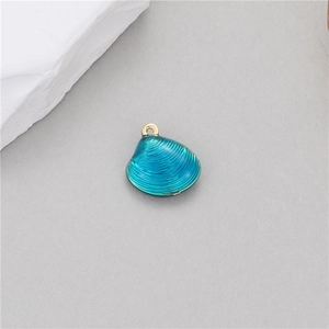 Macro detail of a 14k gold-plated blue shell pendant with textured ridges for jewelry DIY