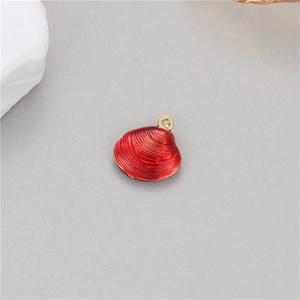 Macro detail of red enamel scallop pendant with gold-plated bail for jewelry making
