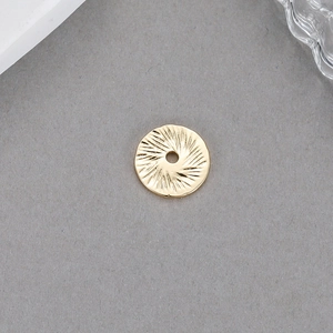 Detail of 14K gold plated stainless steel round pendant with radial texture for DIY jewelry
