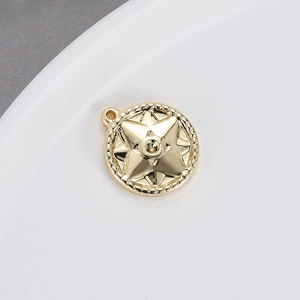 Close-up of 14K gold plated round starburst charm for DIY jewelry making