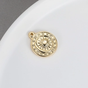 Macro detail of gold plated sun and moon pendant for DIY jewelry necklace accessories