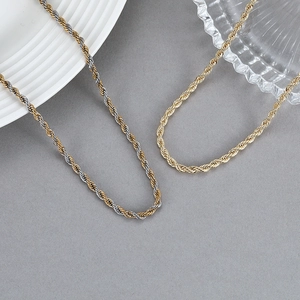 Classic rope chain necklaces in gold and two-tone finishes on a minimalist background