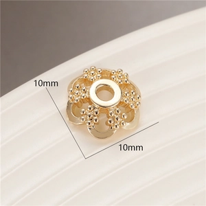 Detailed macro view of 10mm golden flower-shaped bead spacers for DIY jewelry making