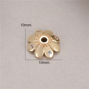 Macro shot of 10mm gold-plated flower bead spacer with micro-inlaid zircons for DIY jewelry