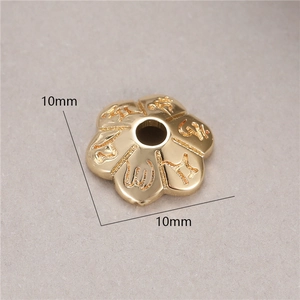 Macro shot of 10mm gold-plated flower spacer bead with engraved Buddhist mantras