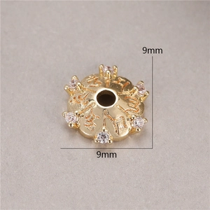 Macro shot of 9mm gold plated spacer bead with clear rhinestones and engraved details
