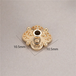 Macro detail of 10.5mm gold flower-shaped spacer bead with embossed texture