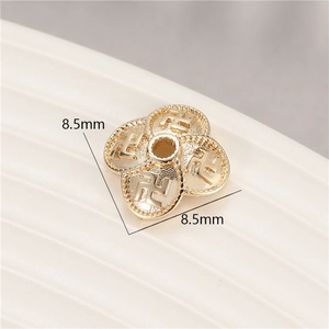 Macro detail of 8.5mm 14K gold-plated flower bead cap with embossed pattern for DIY jewelry