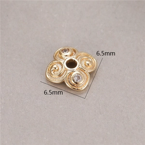 Detailed macro of 14K gold-plated clover spacer bead with 6.5mm size and zircon stones