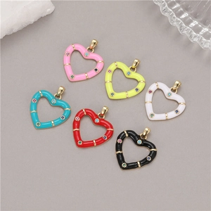 Macro detail of six colorful heart charms with enamel coating and micro-set cubic zirconia