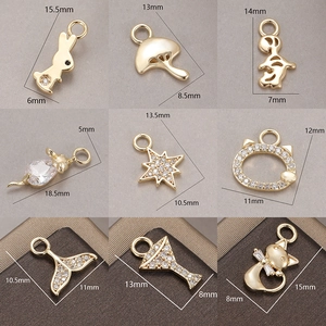 Macro display of nine gold-plated DIY jewelry pendants with cubic zirconia inlay details