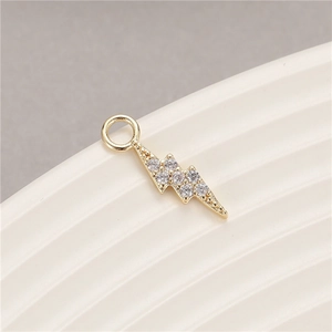 Macro view of gold plated lightning bolt pendant with micro-pave cubic zirconia stones