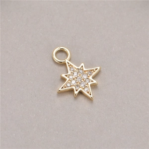 Macro shot of gold star pendant with micro-paved zircons and integrated attachment ring