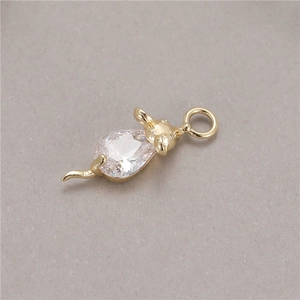 Detailed close-up of a gold mouse pendant featuring a teardrop-shaped cubic zirconia gemstone
