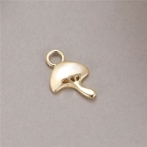 Minimalist mushroom pendant in polished gold finish with a closed ring for DIY jewelry
