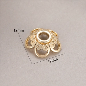 Macro detail of 12mm golden flower bead caps for DIY jewelry making accessories