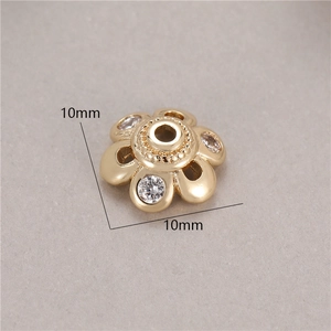 Macro view of 10mm gold flower spacer bead with sparkling zirconia for jewelry making