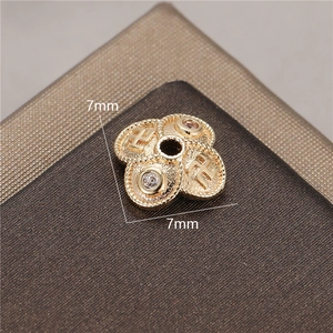 Detailed view of 14K gold-plated 7mm flower bead cap spacer with small gemstones