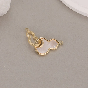 Detail of gold gourd connector with white mother of pearl inlay for DIY jewelry