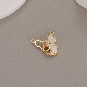 Detail view of gold hollow and pink mother of pearl gourd pendants for necklaces