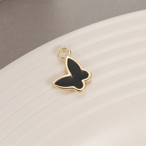 Close-up of 14K gold plated butterfly pendant with black enamel for DIY jewelry making