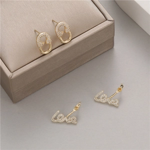 Elegant gold Love letter and safety pin stud earrings with micro-paved zircons